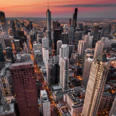 Skysrapers in a city at sunset.