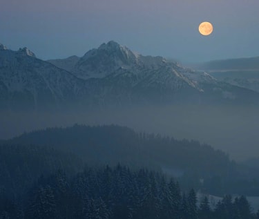 A hazy mountain in the moonlight.